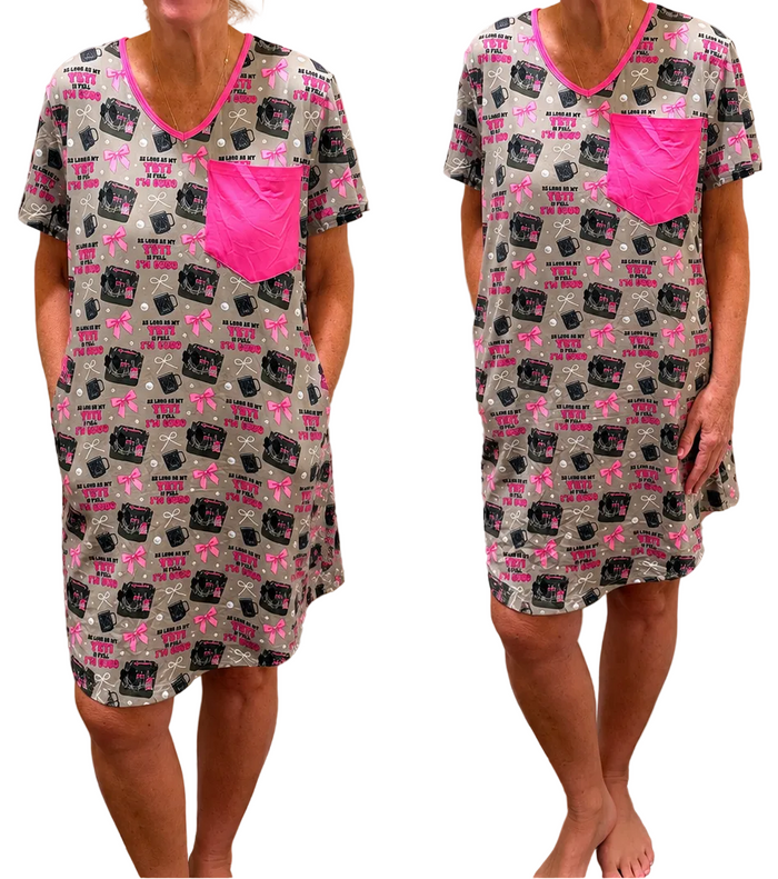 Woman wearing a patterned nightshirt with pink accents in front of a mirror.