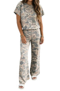 Person wearing a matching camouflage outfit standing against a white wall.