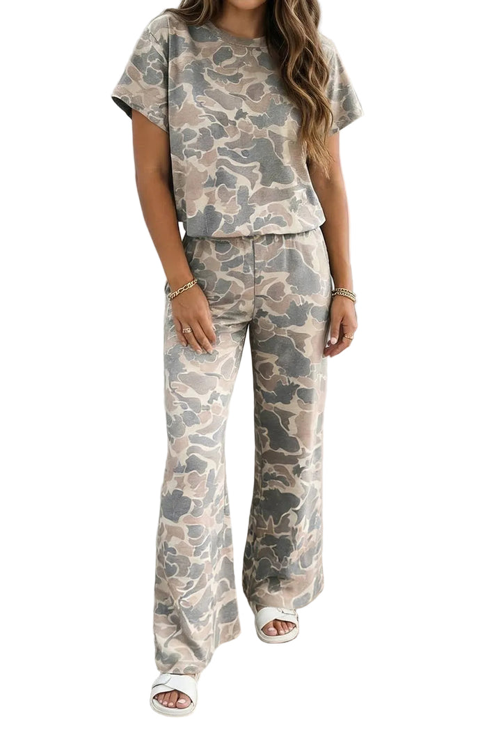 Person wearing a matching camouflage outfit standing against a white wall.