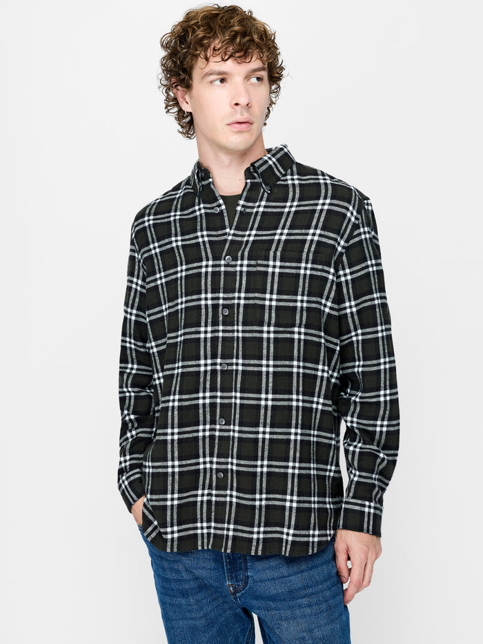 A man wearing a black and white check pattern Shirt ewith long sleeves, a pointed oxford collar, a chest patch pocket, button through fastening and a regular fit.