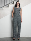 A woman wearing a black and white tweed straight leg trousers with a high waist, 2 side pockets and a full length regular fit.